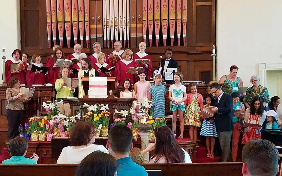 A choir and church members sing at First Parish